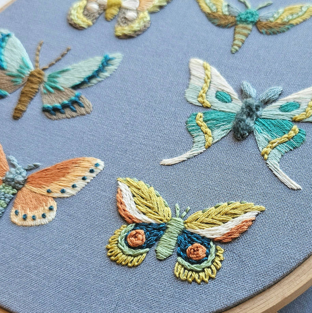 Embroidered butterflies on a blue fabric background