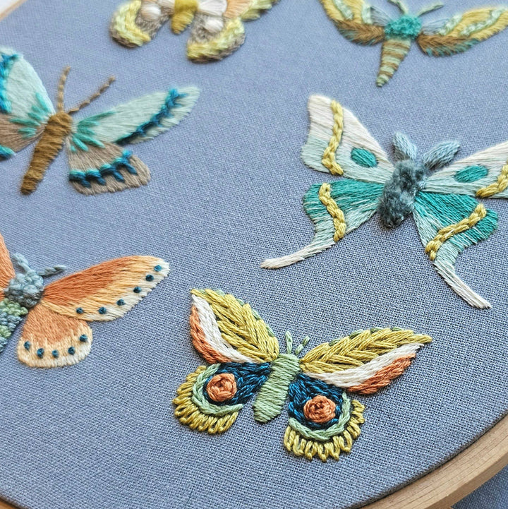 Embroidered butterflies on a blue fabric background