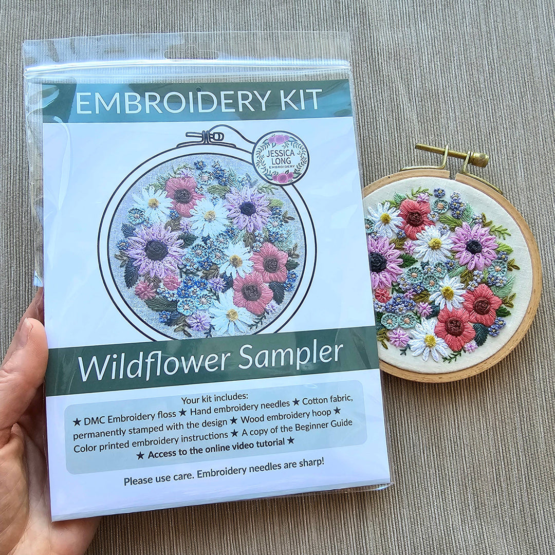 Embroidery kit with wildflower sampler design on a gray surface