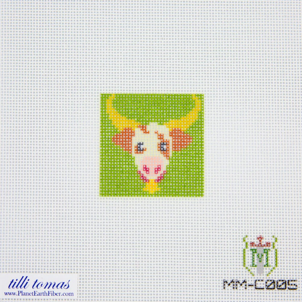 Needlepoint canvas cow design on fabric with 'tilliomas' branding.