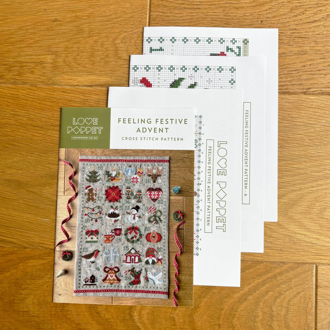 Cross stitch pattern books on a wooden surface