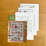 Cross stitch pattern books on a wooden surface