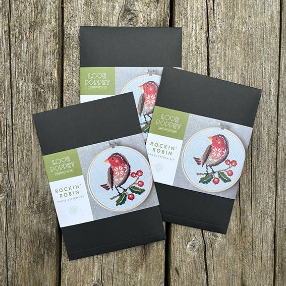 Three 'Rockin' Robin' embroidery kit boxes on a wooden surface