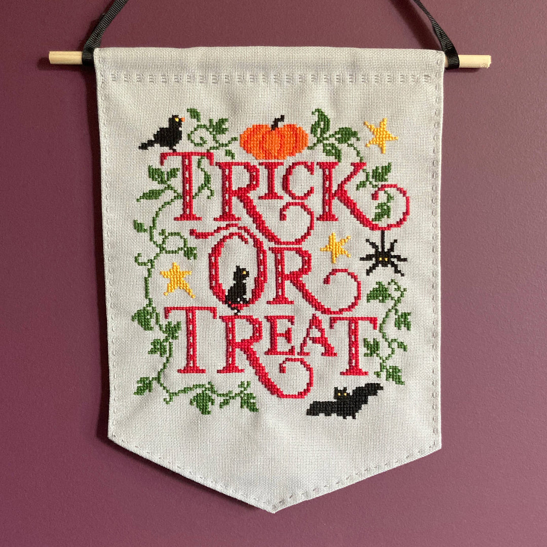 Embroidered banner with 'Tricks or Treat' text on a purple background