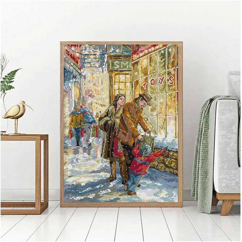 Framed artwork of a couple and child in a snowy street scene with a toy store window.