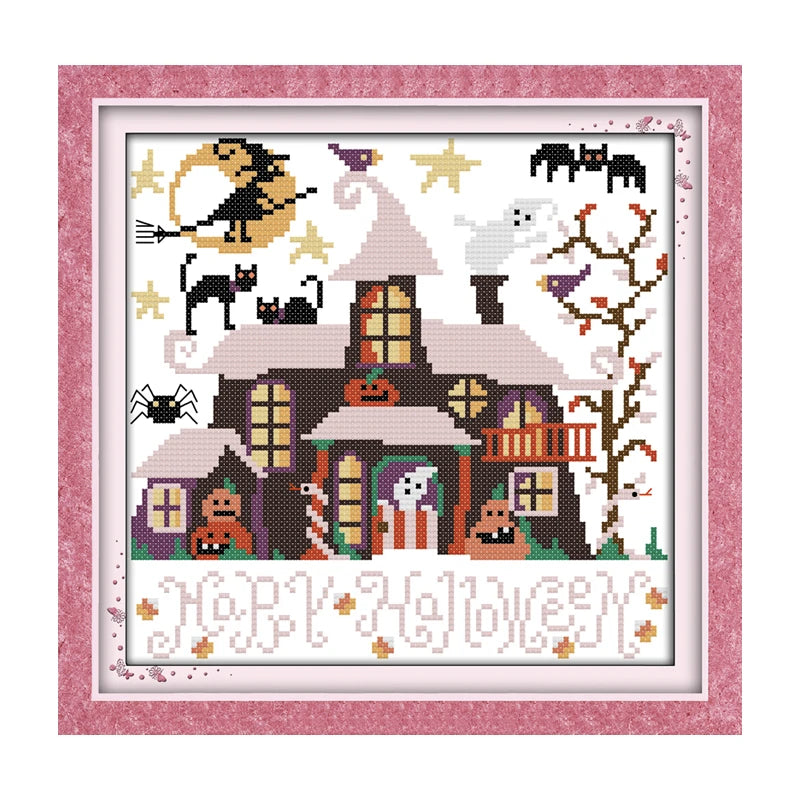 Halloween-themed cross-stitch pattern with a house, cats, and ghosts on a pink frame.