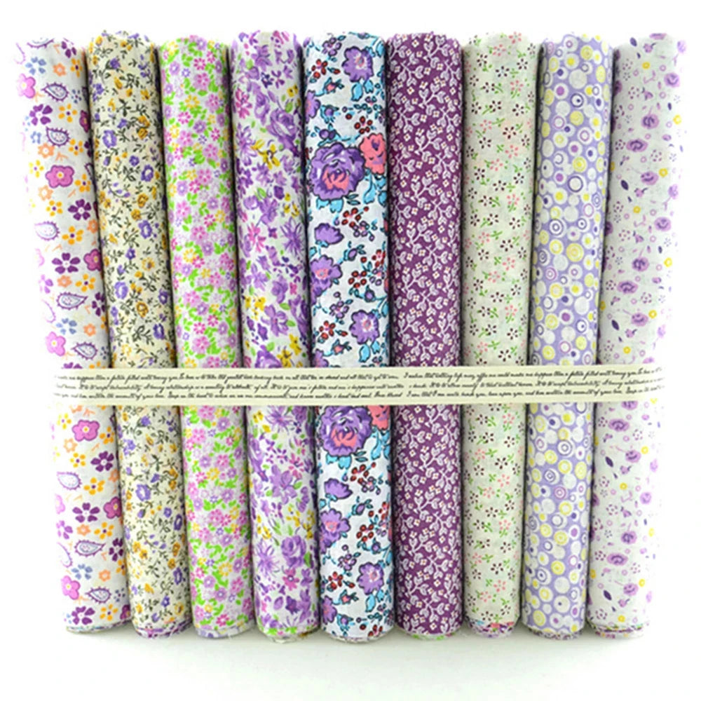 Set of floral fabric rolls in various patterns on a white background
