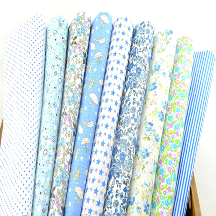Collection of blue and white patterned fabrics arranged in a row.
