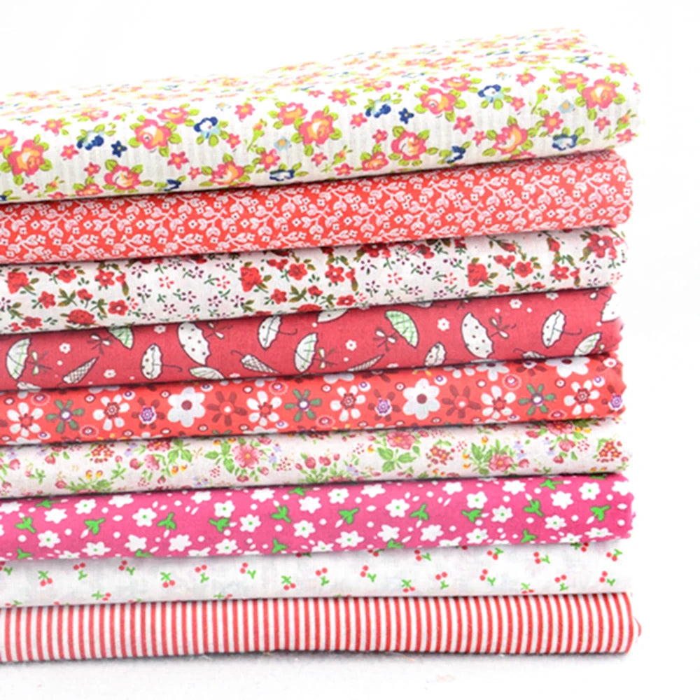 Stack of colorful floral and striped fabric sheets on a white background