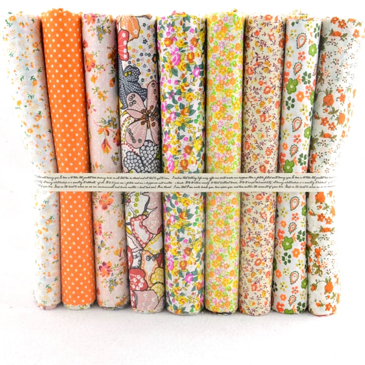 Collection of colorful fabric rolls with various patterns on a white background