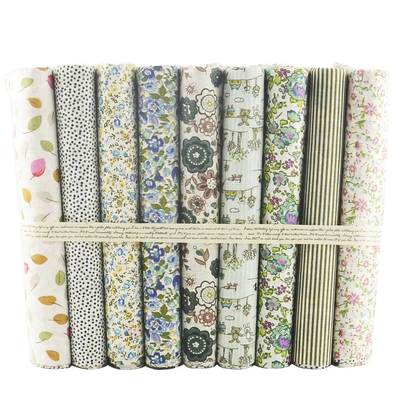 Set of fabric bundles with various patterns tied together on a white background