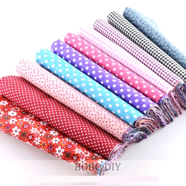 Set of colorful fabric rolls with various patterns on a white background, featuring the brand 'BOBODIY'.