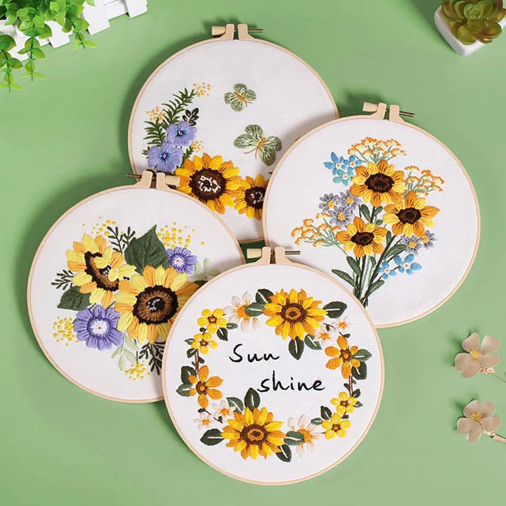 Set of embroidery hoops with floral designs on a green background