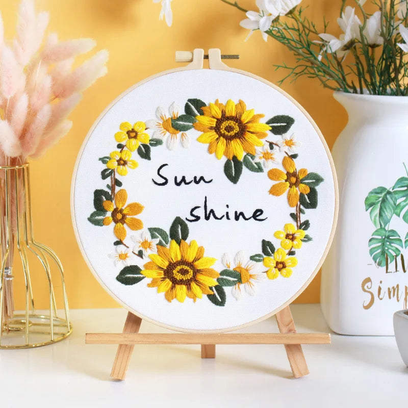 Decorative hoop with sunflower design and 'Sunshine' text on a stand.