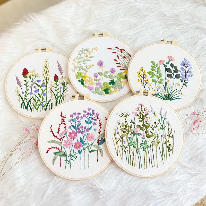 Set of embroidery hoops with floral patterns on a soft white background