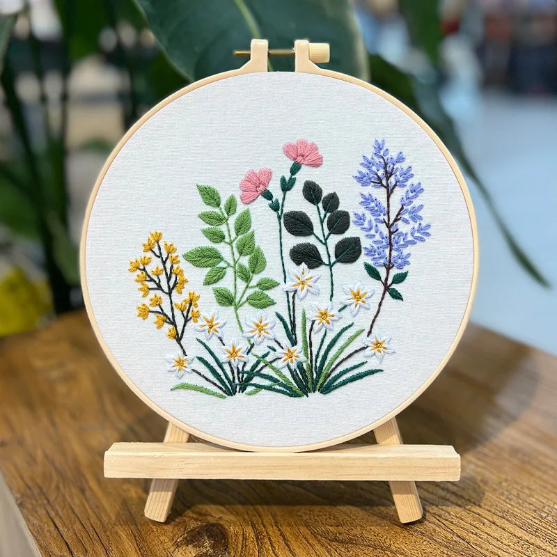 Embroidery hoop with floral design on a wooden stand