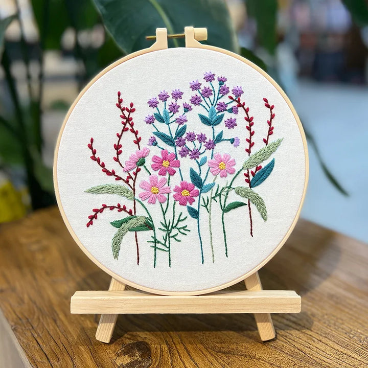 Embroidery hoop with floral design on a wooden stand