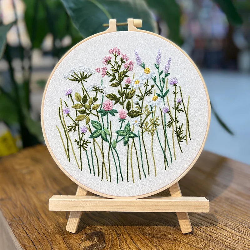 Embroidery hoop with floral design on a wooden stand