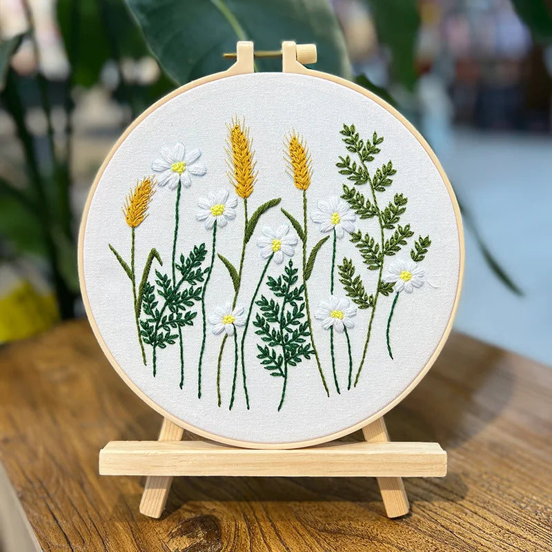 Embroidery hoop with floral design on a wooden stand