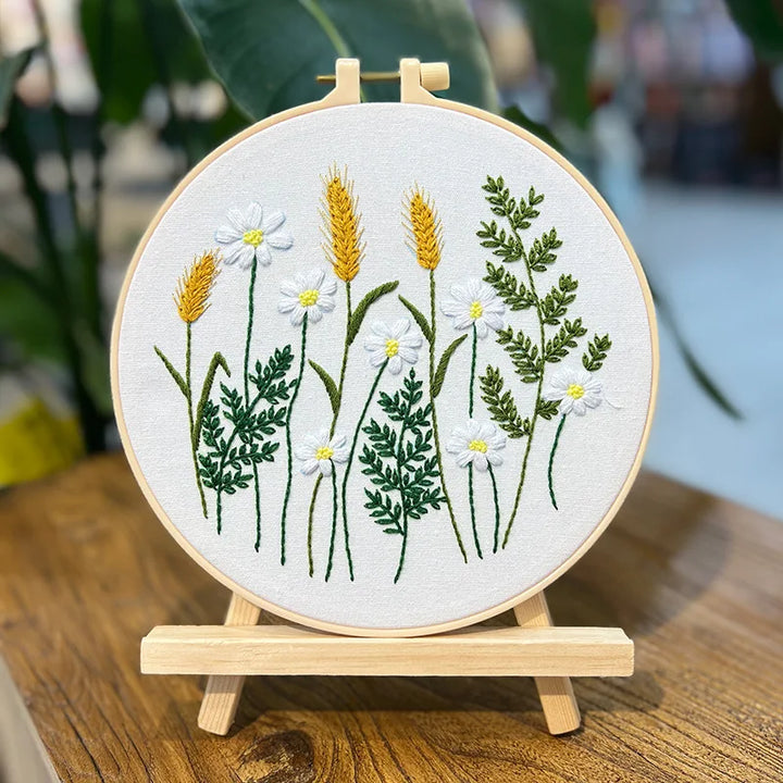 Embroidery hoop with floral design on a wooden stand