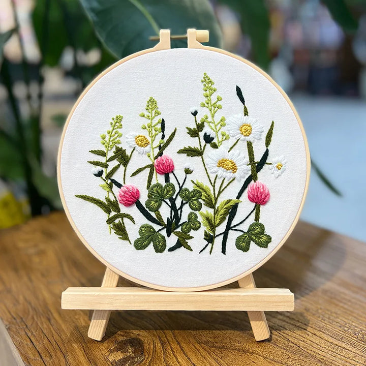 Embroidery hoop with floral design on a wooden stand