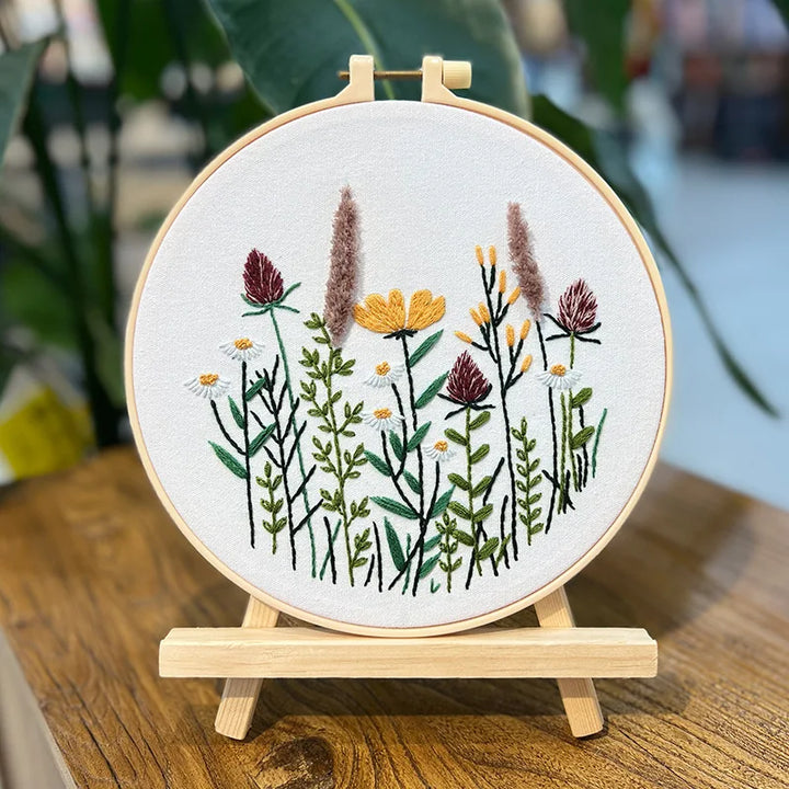 Embroidery hoop with floral design on a wooden stand