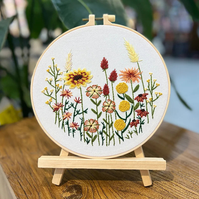 Embroidery hoop with floral design on a wooden stand