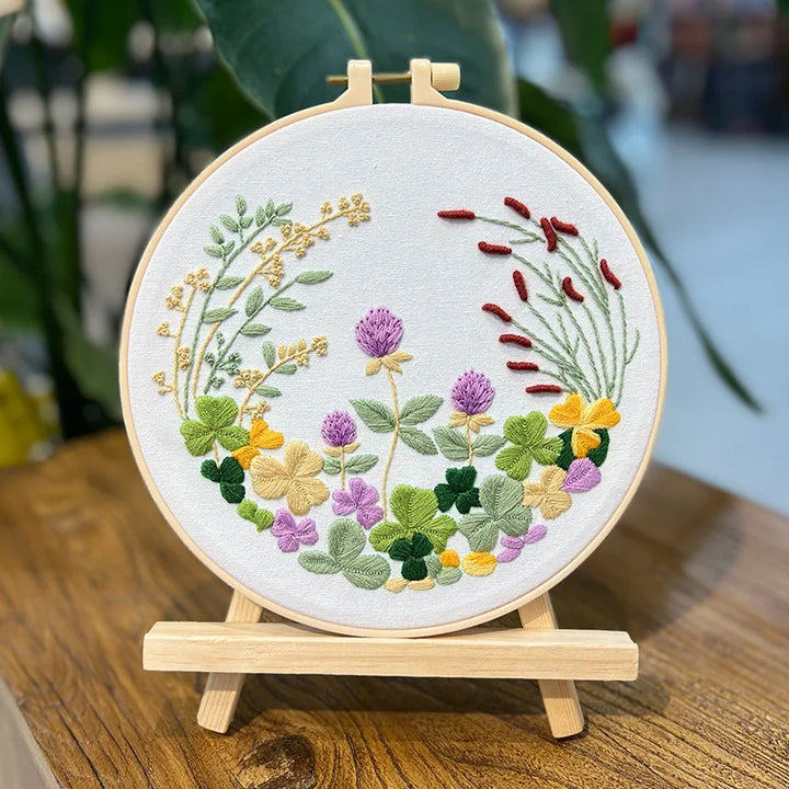 Embroidery hoop with floral design on a wooden stand
