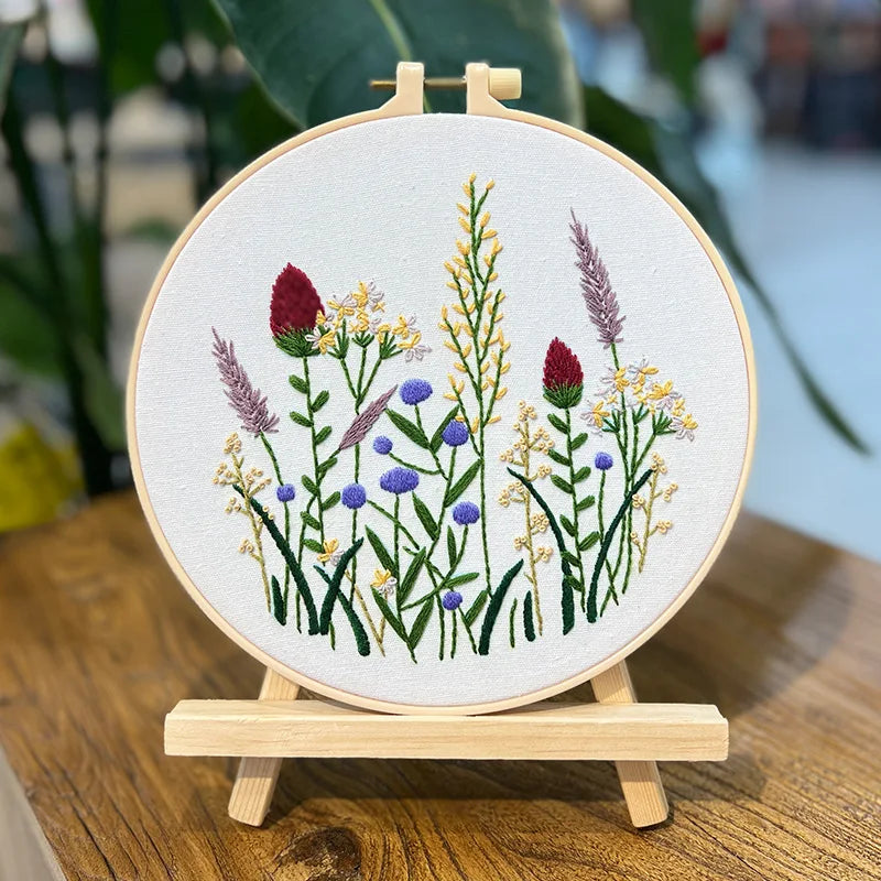 Embroidery hoop with floral design on a wooden stand