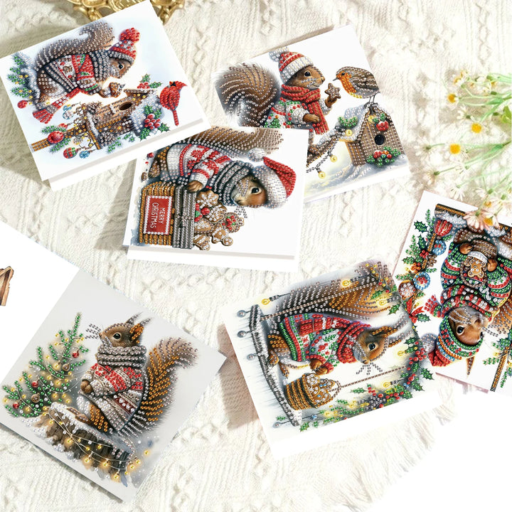Collection of diamond painting cards featuring festive animals on a textured surface.
