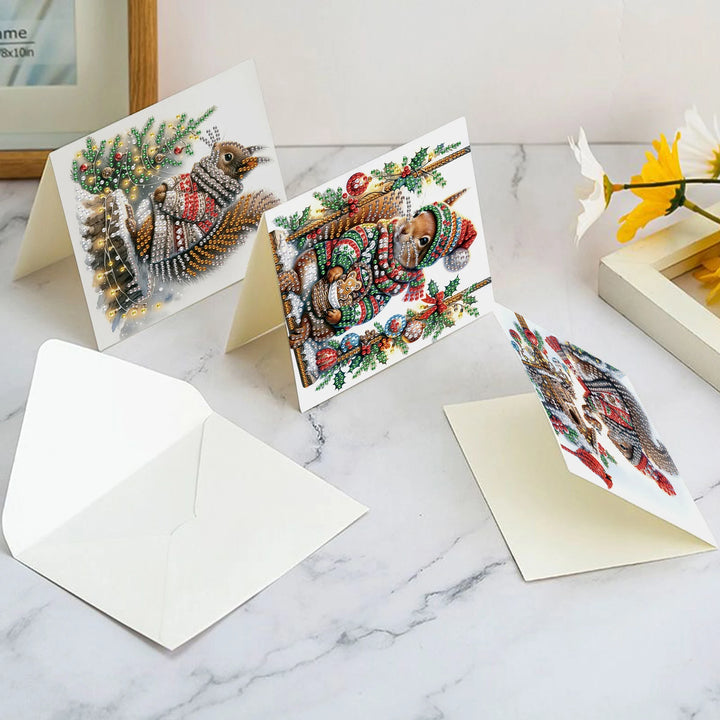 Set of Christmas-themed greeting cards with decorative animals on a marble surface.