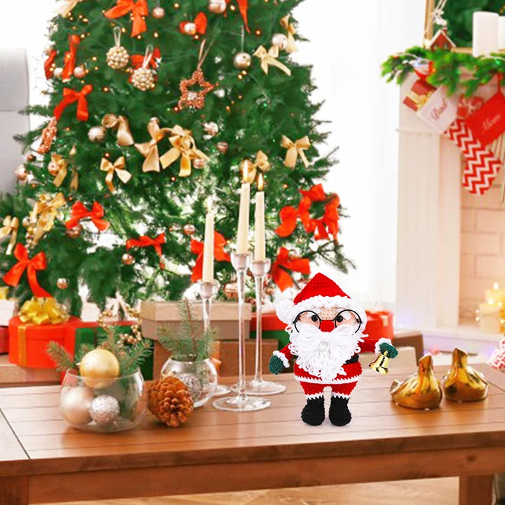 Decorative Santa figure on a table with a Christmas tree in the background