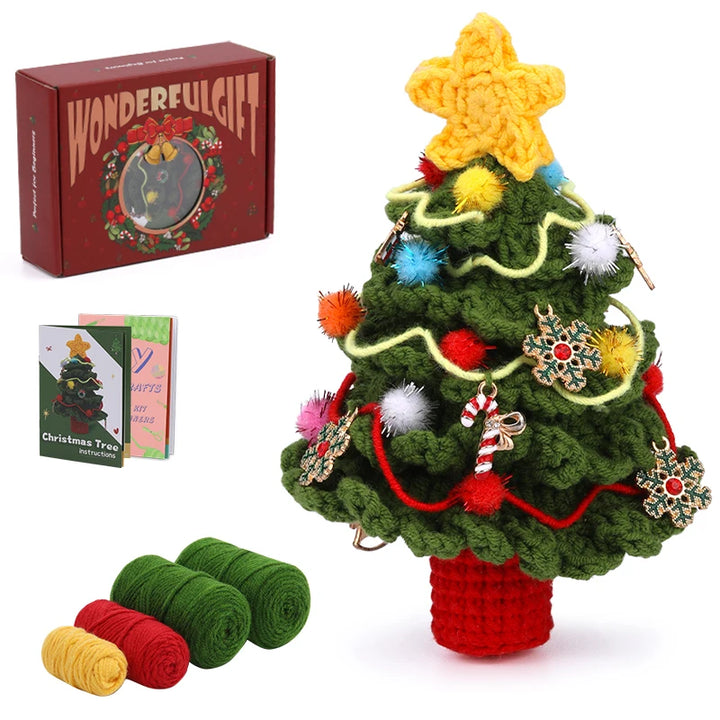 Crocheted Christmas tree with colorful decorations, yarn rolls, and packaging on a white background