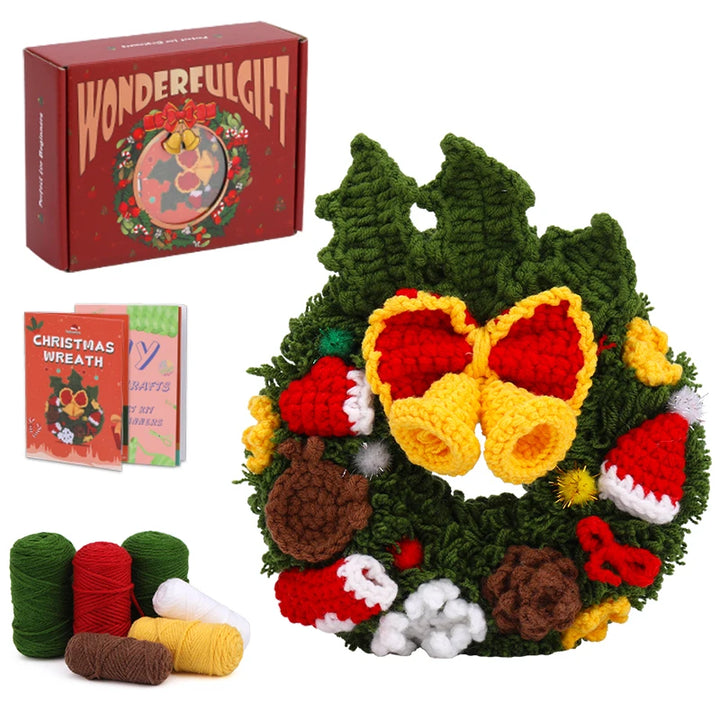 Crocheted Christmas wreath with yarn skeins and a 'WonderfulGift' box on a white background