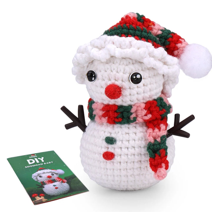 Crocheted snowman toy with a patterned scarf and hat, next to a DIY snowman kit on a white background.