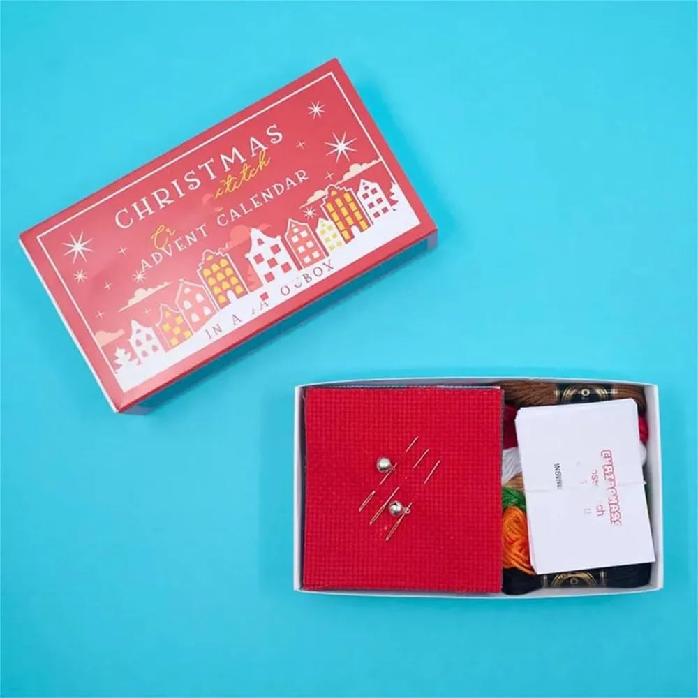 Christmas stitch advent calendar with open box on a blue background