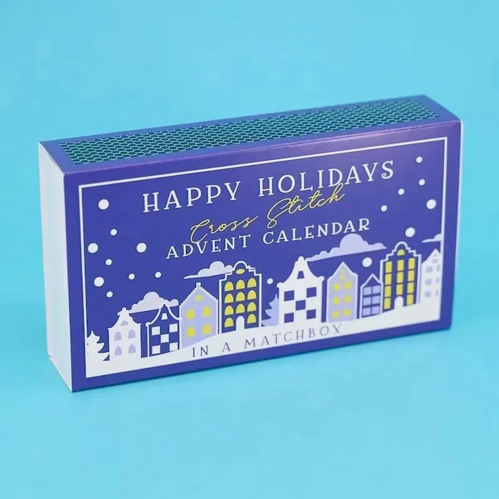 Advent calendar packaging with 'Happy Holidays Cross Stitch Advent Calendar' text on a blue background