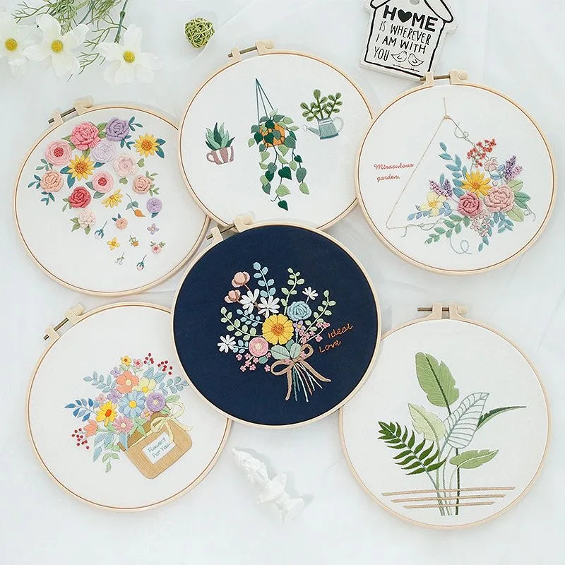 Collection of embroidered hoop art with floral and botanical designs on a white background.