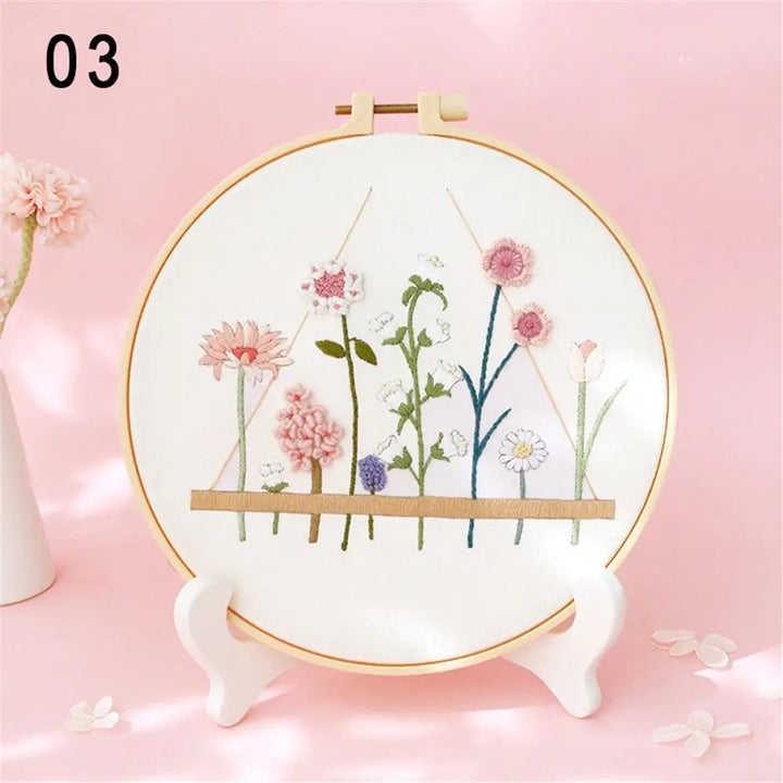 Embroidery hoop with floral design on a pink background