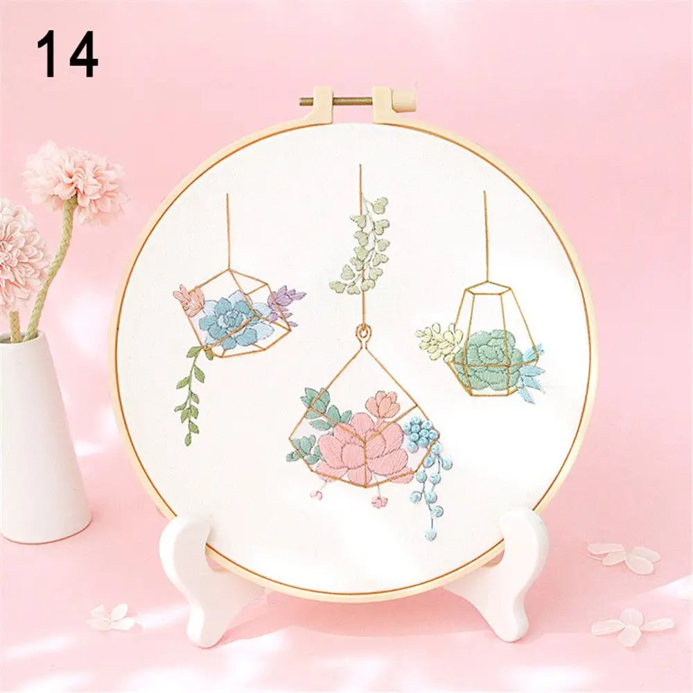 Embroidery hoop with floral design on a pink background