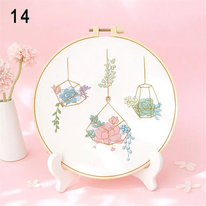 Embroidery hoop with floral design on a pink background