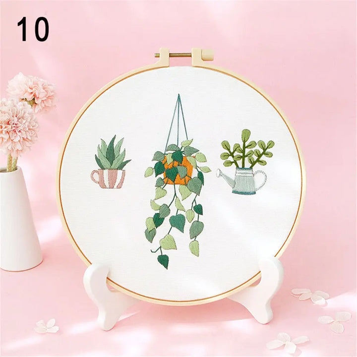 Embroidery hoop with plant designs on a pink background