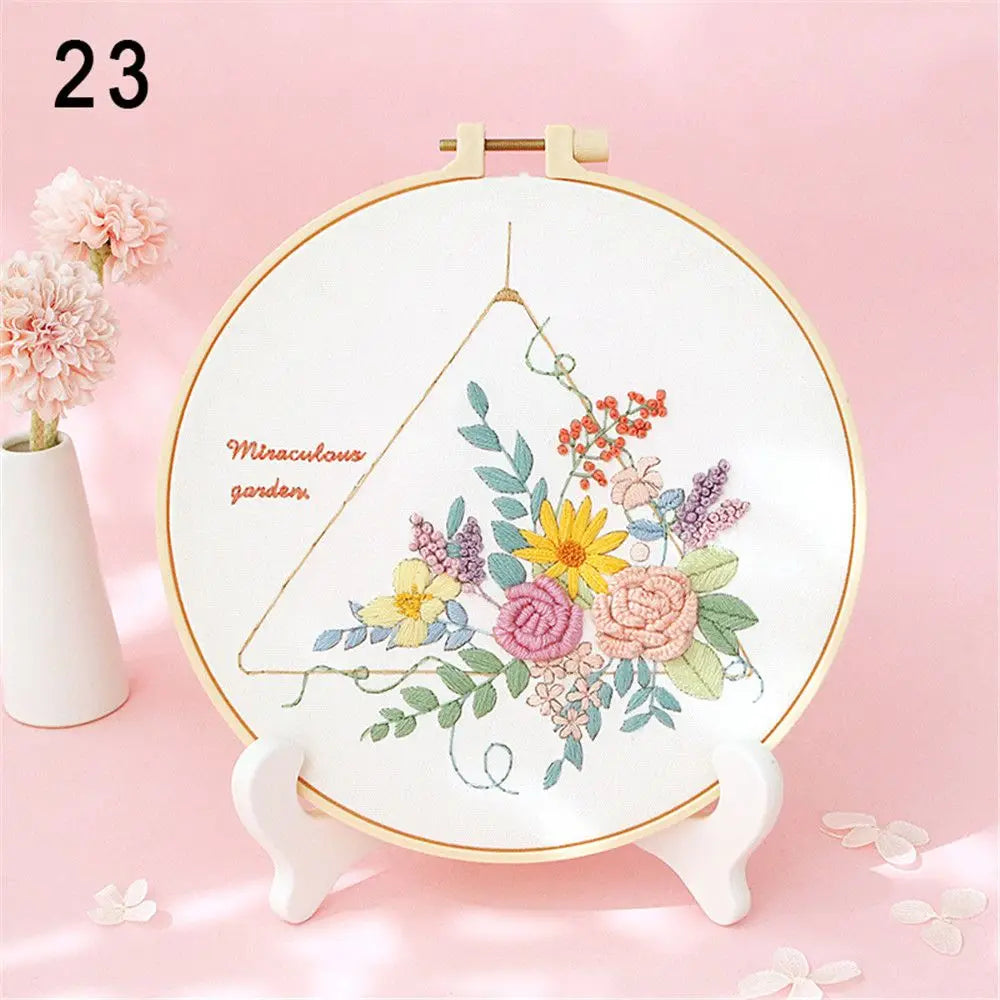 Embroidery hoop with floral design on a pink background