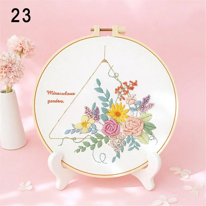 Embroidery hoop with floral design on a pink background