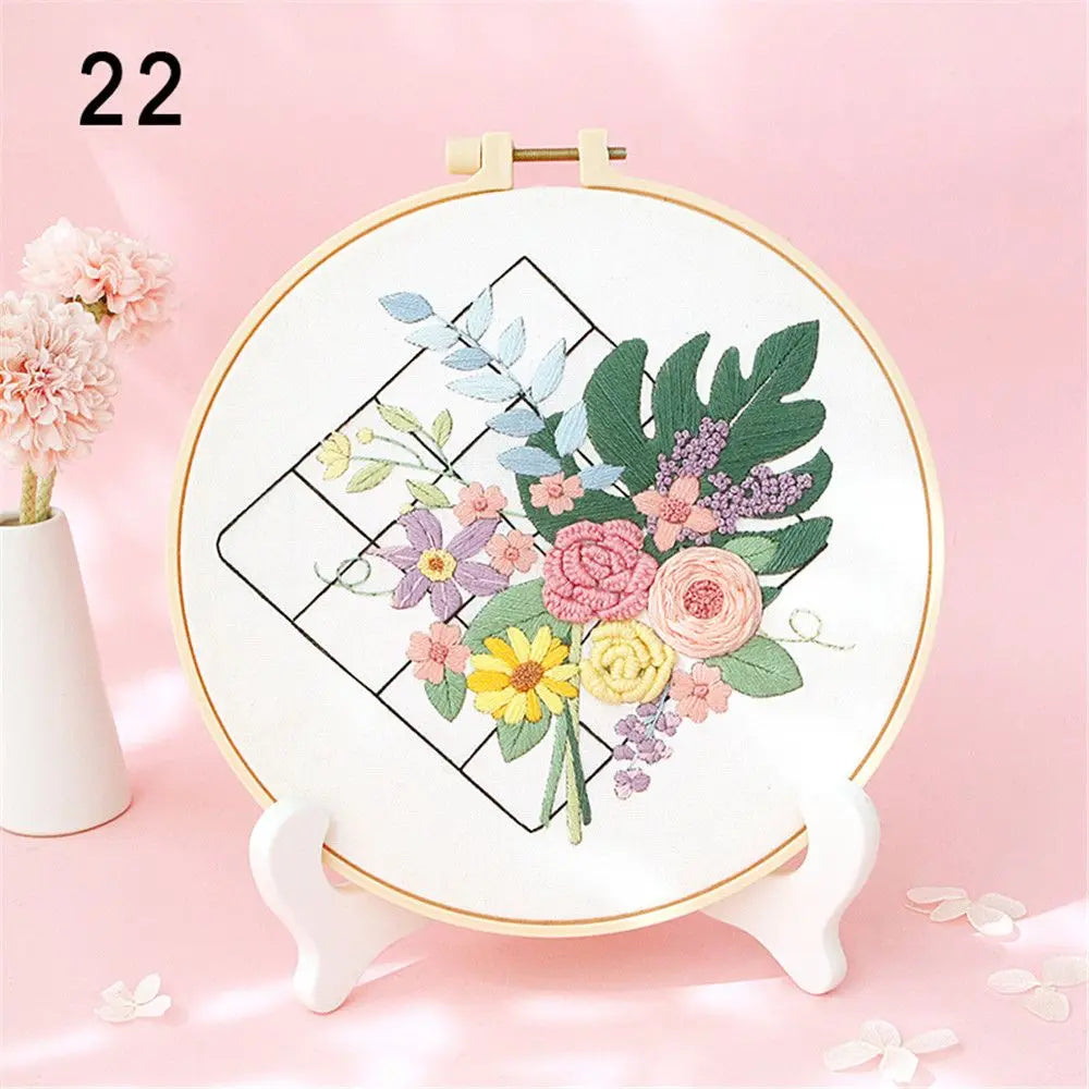 Embroidery hoop with floral design on a pink background