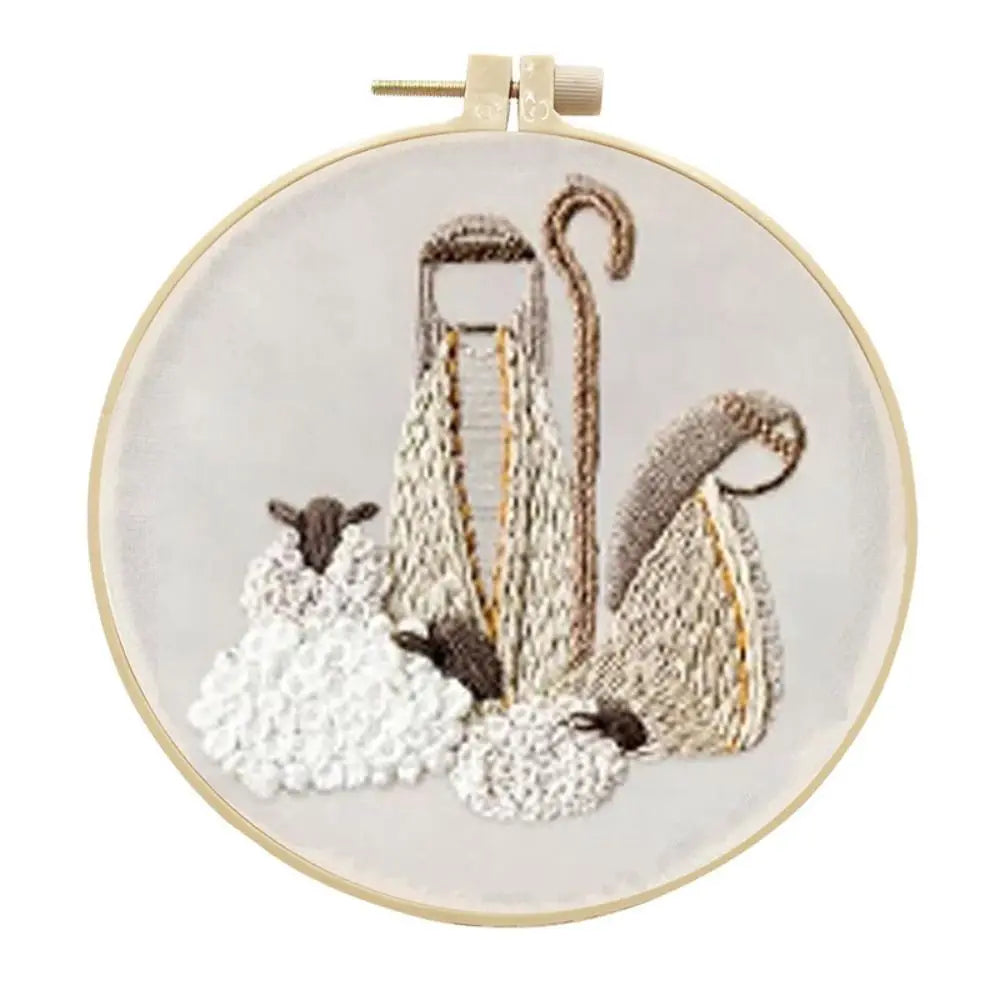 Embroidery hoop with sheep and shepherd's crook design on a white background
