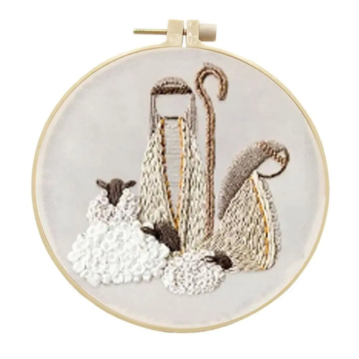 Embroidery hoop with sheep and shepherd's crook design on a white background