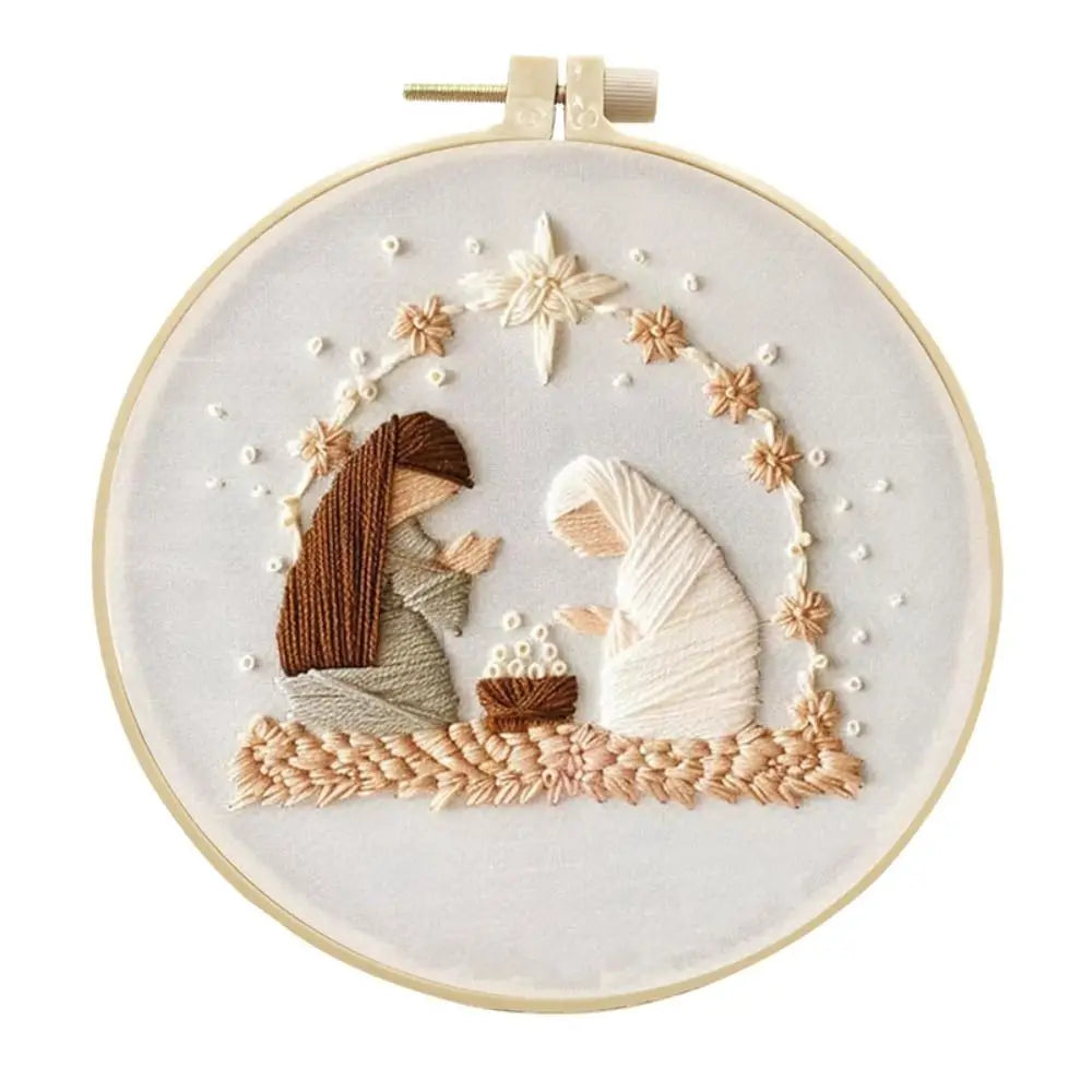 Embroidery hoop with a religious scene featuring two figures and a star on a white background