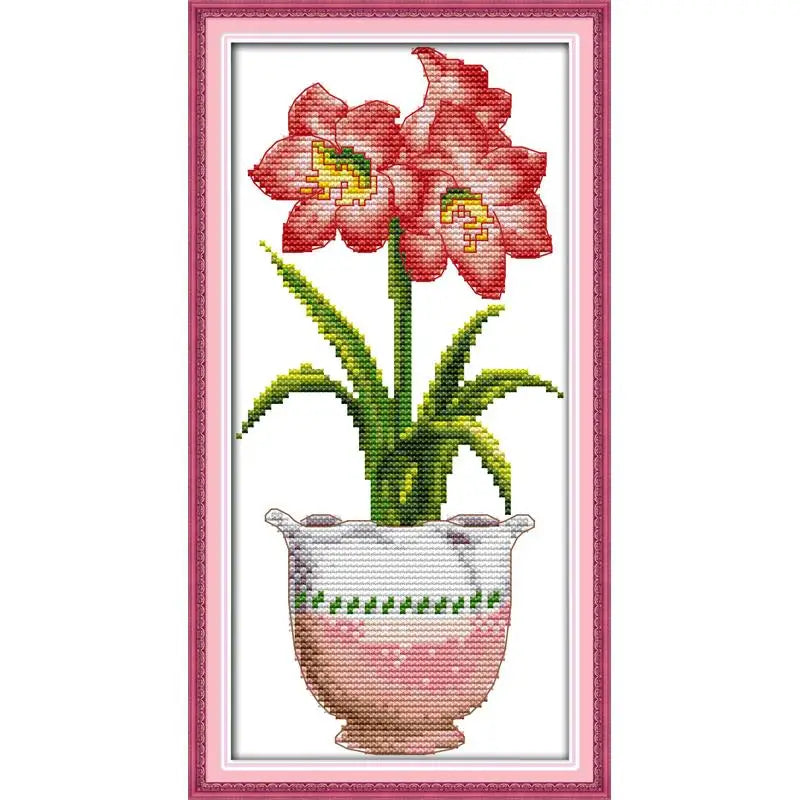 Cross-stitched design of pink flowers in a vase with a pink frame.