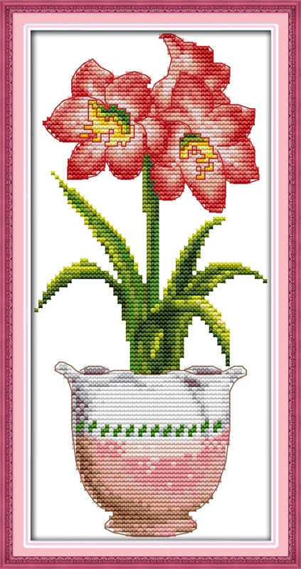 Cross-stitched design of pink flowers in a vase with a pink border